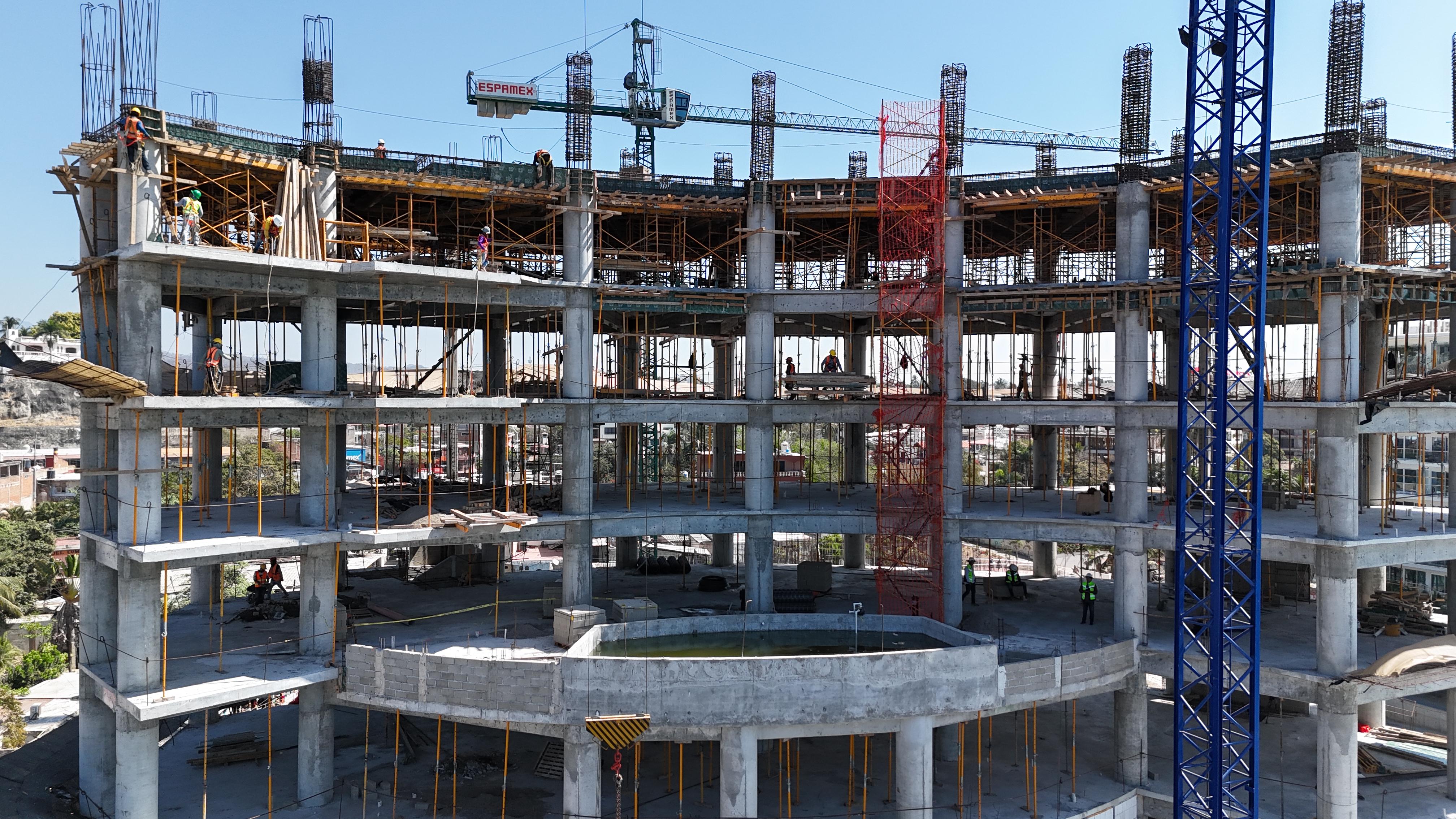 Estructura en obra con grúa y trabajadores — AV Construinstalaciones